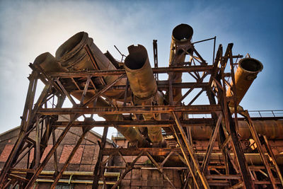 Low angle view of man standing at construction site against sky