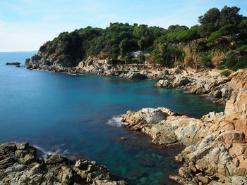 Scenic view of sea and mountains against sky