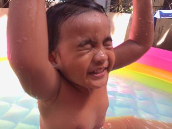 Close-up portrait of cute baby girl in swimming pool