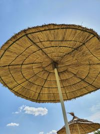 Low angle view of parasol against sky