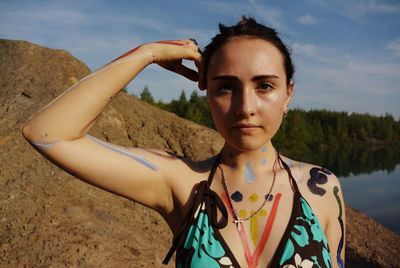 Portrait of a young woman standing on beach
