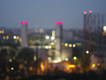 Defocused image of illuminated city at night