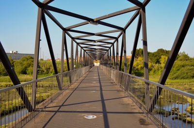 View of footbridge against clear sky