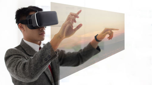 Midsection of man using mobile phone