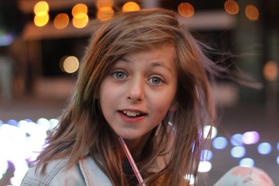 Close-up portrait of girl at night