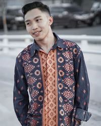 Portrait of young man standing outdoors