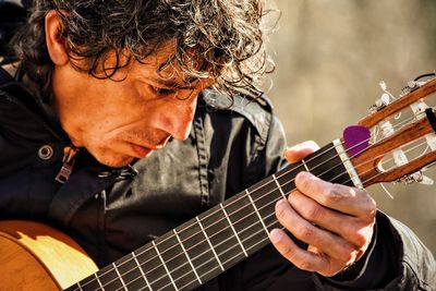 Close-up of man playing guitar