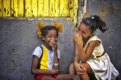 Happy friends sitting on floor