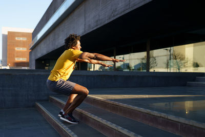 Full length of man exercising in city