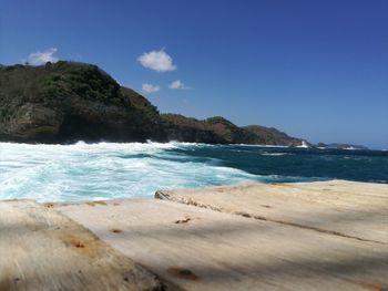 Scenic view of beach against blue sky