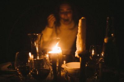 View of lit candles on table