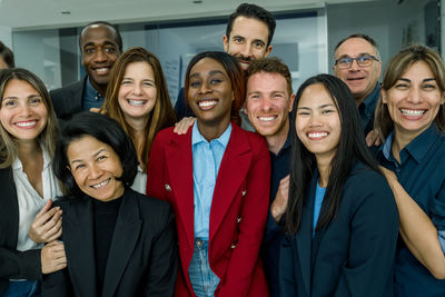 Group of cheerful diverse colleagues in office