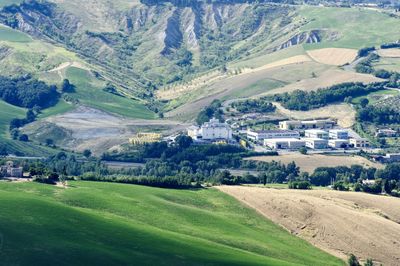 Scenic view of agricultural field by houses and mountains