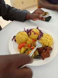 Cropped hand of food in plate