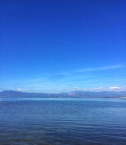 Scenic view of sea against blue sky