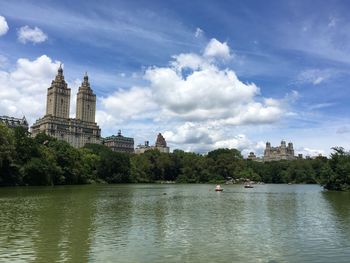 View of buildings in city against cloudy sky