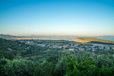 Aerial view of townscape against clear blue sky