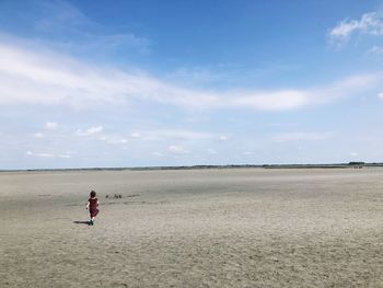 Woman on beach against sky