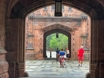 Rear view of people riding bicycle