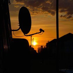 Low angle view of street light against sky at sunset