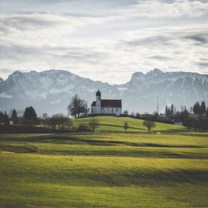 Scenic view of field and mountains against sky