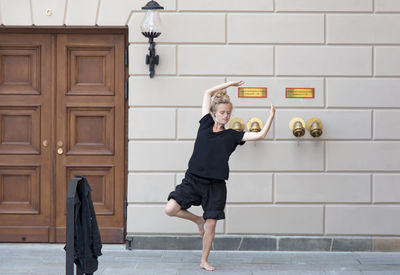 Full length of woman holding umbrella