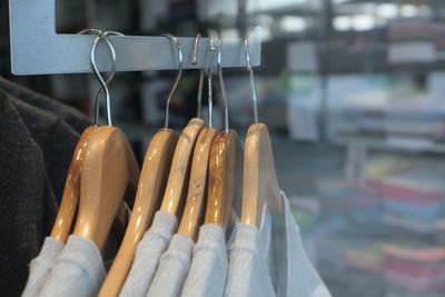 Close-up of clothes hanging on rack in store