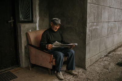 Portrait of young man sitting on chair