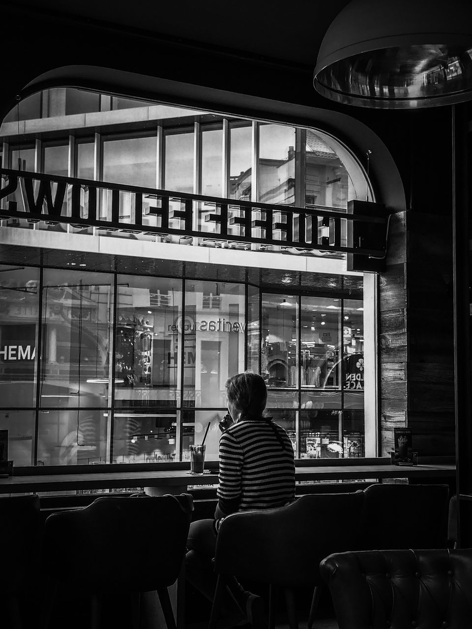 real people, one person, sitting, window, rear view, transparent, seat, lifestyles, glass - material, leisure activity, chair, adult, men, transportation, mode of transportation, indoors, public transportation, built structure, travel, waiting