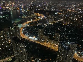 High angle view of city lit up at night