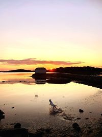 Scenic view of lake against sky during sunset
