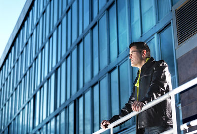 Low angle view of man standing against building