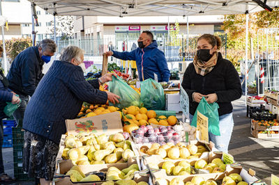 Group of people at market stall