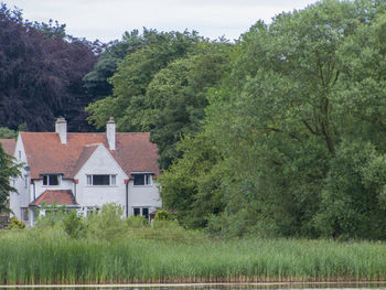 House by trees against sky