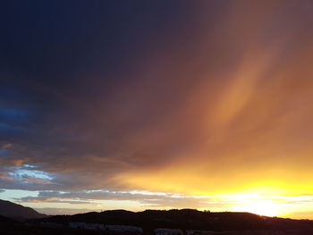 Scenic view of dramatic sky during sunset