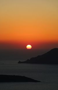 Scenic view of sea against romantic sky at sunset