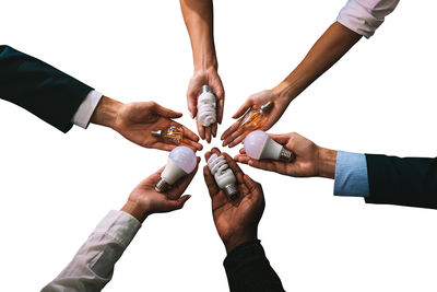 Cropped image of business colleagues shaking hands against white background
