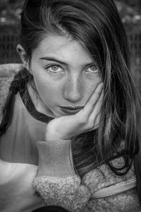 Close-up portrait of girl with hand on chin