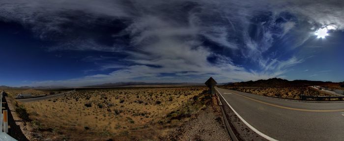 Panoramic shot of road on land against sky
