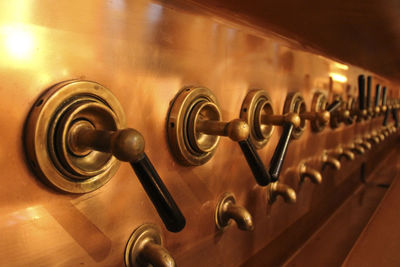 Close-up of brewery beer taps at bar