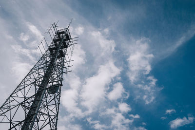 Low angle view of communications tower against sky