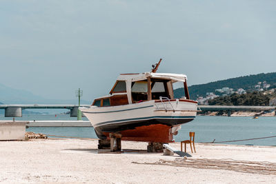 Boat being repaired and repainted on dry dock near sea