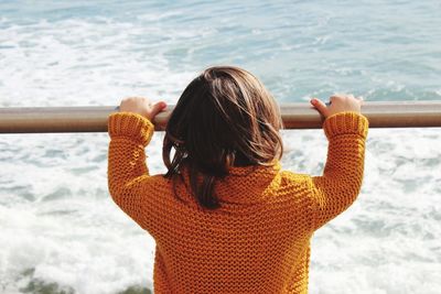 Rear view of woman against sea