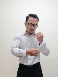 Young man standing against white background