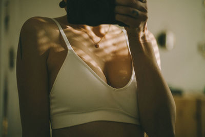 Midsection of woman holding umbrella