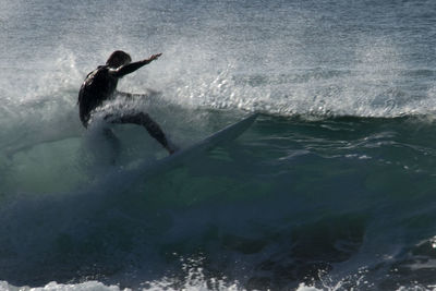 Woman jumping in sea