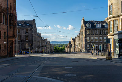 View of city street and buildings against sky