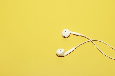 Close-up of electric lamp against yellow background