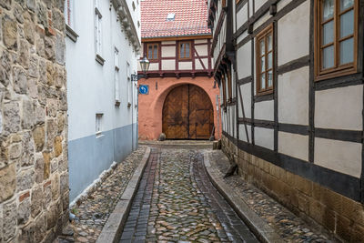 Empty alley amidst buildings in city