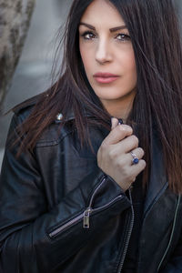 Close-up portrait of beautiful woman wearing leather jacket